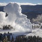 Rising steam from Old Faithful hangs in the frigid air as seen from Observation Point in Yellowstone National Park during February 2014 cold snap.