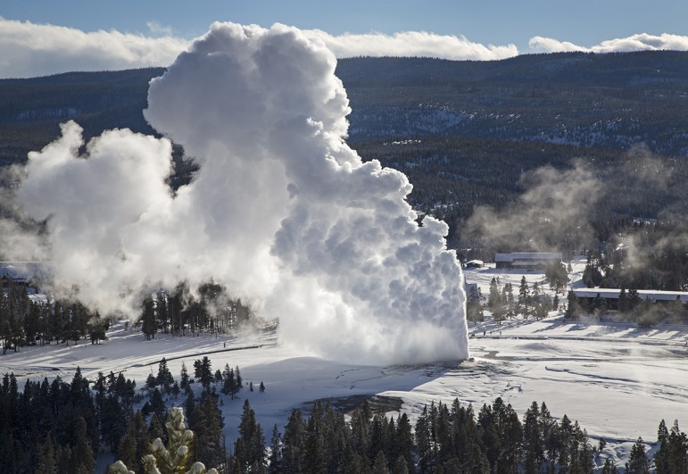 Rising steam from Old Faithful hangs in the frigid air as seen from Observation Point in Yellowstone National Park during February 2014 cold snap.