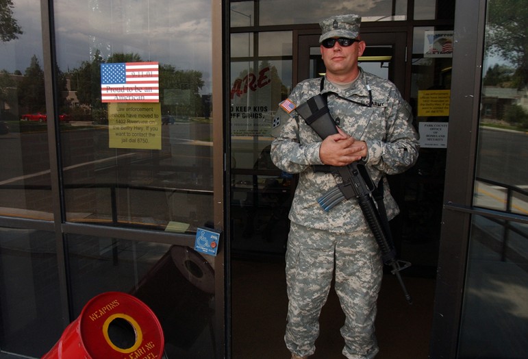 A member of the Wyoming National Guard, who asked not to be identified, stands guard  at the entrance to the old Law Enforcement Center at Beck Avenue and 11th Street during the 2006 Hells Angels World Run in Cody, Wyo.