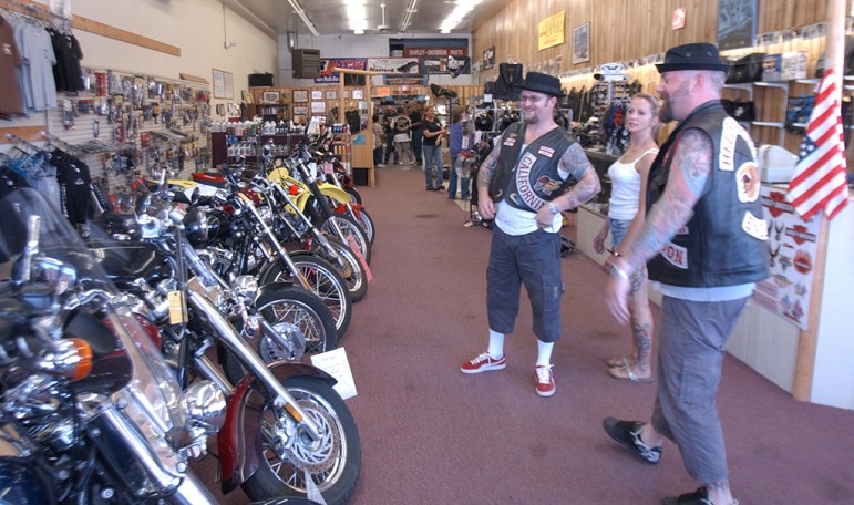 Members of the Hells Angels Motorcycle Club and a friend check out the bikes at Cody Custom Cycle during the group's 2006 World Run in Cody, Wyo.