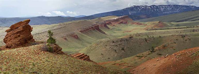 Red clay stands out in a dramatic view of the landscape as seen from the Bald Ridge trail east of Cody, Wyo. (©Kathy Lichttendahl)