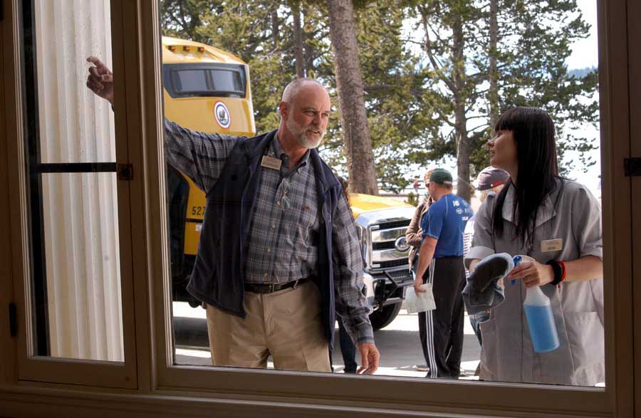 Rick Hoeninghausen, director of sales and marketing for Xanterra Parks & Resorts, points out a few spots where last-minute window clenaing is needed by Michaela Matuskva before a ribbon-cutting celebrating completion of a 2-year, $28.5 million renovation of Lake Hotel in Yellowstone National Park.