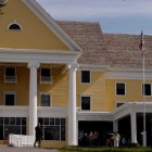 People gather Tuesday for a ribbon-cutting celebrating completion of a 2-year, $28.5 million renovation of Lake Hotel in Yellowstone National Park.