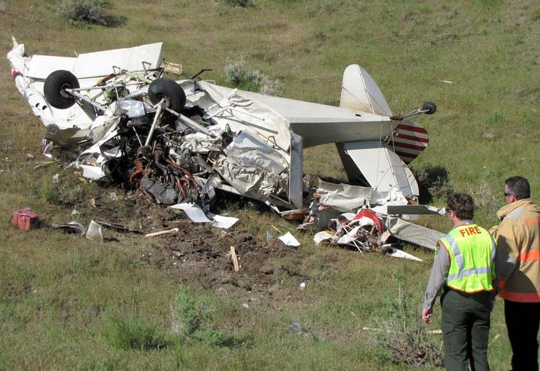 Emergency responders view the wreckage of a small plan that crashed Monday in Yellowstone National Park.