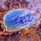 Grand Prismatic Spring is the largest hot spring in Yellowstone National Park. Its colors are the result of different forms of microbial life thriving in different temperature zones.