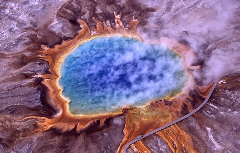Grand Prismatic Spring is the largest hot spring in Yellowstone National Park. Its colors are the result of different forms of microbial life thriving in different temperature zones.