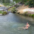 Alyssa Ammen and Ben Griffith soak in Mr. Bubbles in Yellowstone National Park. Mr.Bubbles is one of the rare places you can soak in Yellowstone because it’s not a thermal feature. Hot water from thermal features nearby mixes with the cold river water.