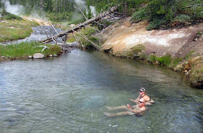 Alyssa Ammen and Ben Griffith soak in Mr. Bubbles in Yellowstone National Park. Mr.Bubbles is one of the rare places you can soak in Yellowstone because it’s not a thermal feature. Hot water from thermal features nearby mixes with the cold river water.