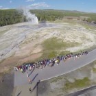 A still image from a video posted to YouTube shows Old Faithful erupting as seen from a camera drone in 2013, before Yellowstone National Park and the National Park Service banned unmanned aerial vehicles.