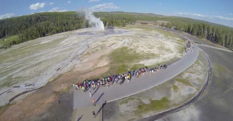 A still image from a video posted to YouTube shows Old Faithful erupting as seen from a camera drone in 2013, before Yellowstone National Park and the National Park Service banned unmanned aerial vehicles.
