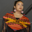 A model wears a garment made by designer Mildred Carpenter of Lodge Grass, Mont. during the Cody High Style Fashion show on Wednesday in Cody, Wyo.