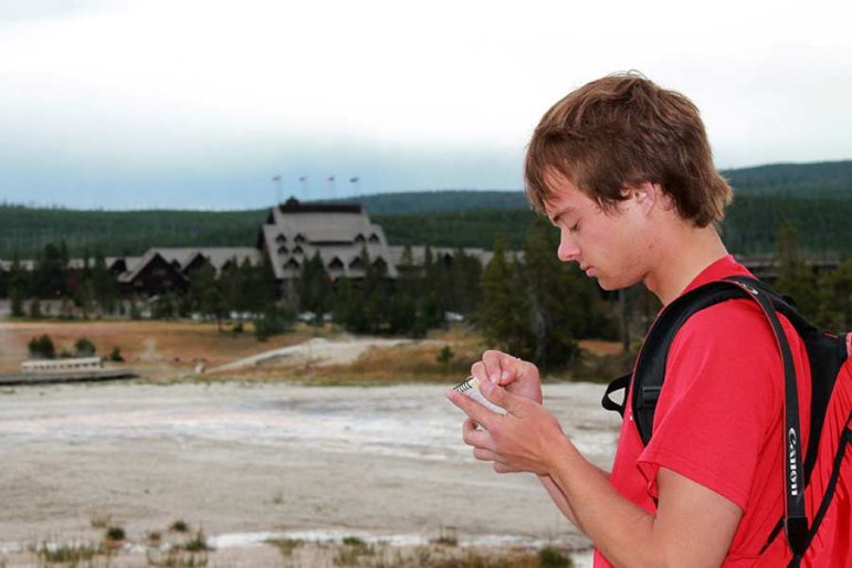 Self-described 'geyser gazer' Ryan Maurer takes notes after the eruptions of Lion Geyser in Yellowstone National Park.