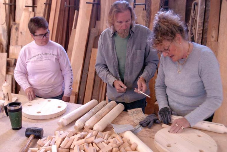 Liz Holmes, left, looks on as furniture designer John Gallis helps Hilary Heminway build a stool during a 2008 workshop as part of the Cody High Style show. Gallis coached a dozen students at his Norseman Designs West workshop on how to create a stool in the style of Western design pioneer Thomas Molesworth.