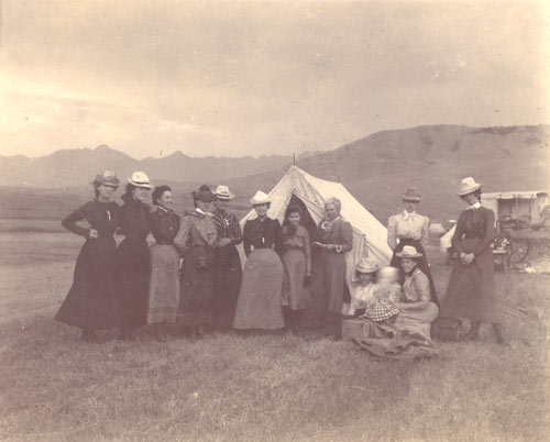 Some women stand around a tent in the Paradise Valley during a 1900 trip to Yellowstone National Park.