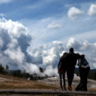 President Barack Obama awaits the eruption of Old Faithful with First Lady Micelle Obama and daughters Sasha and Malia during a 2009 visit to Yellowstone National Park.