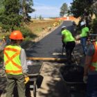 Volunteers help resurface a walking path near Old Faithful geyser in Yellowstone National Park.