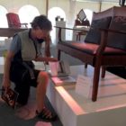 Western design enthusiast Peggy Ruble examines, Teton Settee, created by John Gallis of Norseman Designs West.