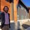 Dylan Hoffman, director of environmental affairs in Yellowstone for Xanterra Parks and Resorts, stands near the entrance to Paintbrush Lodge, a newly completed employee dormitory in Yellowstone National Park.