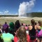 Visitors watch Old Faithful geyser erupt in Yellowstone National Park.