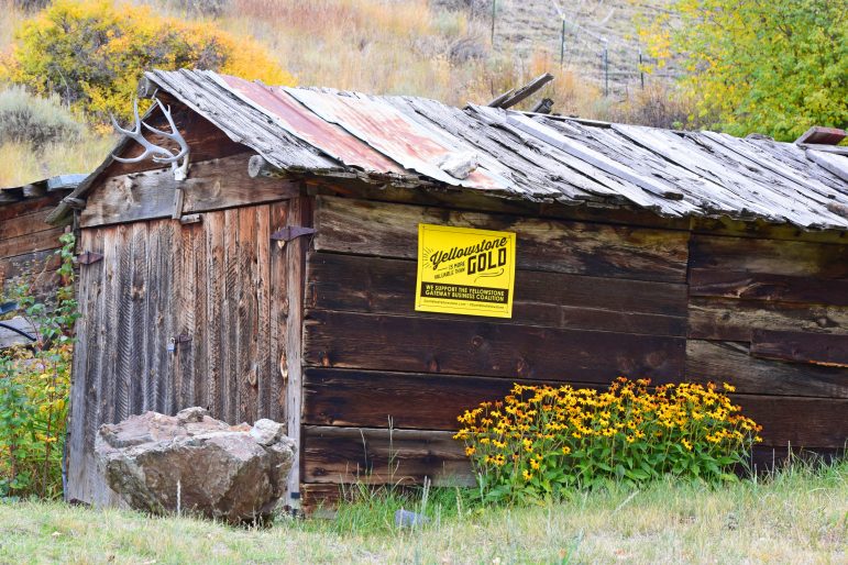 A cabin in Old Chico, Mont., the site of a historic mining community, displays a sign in opposition to new mining proposed for the Paradise Valley.