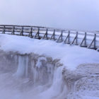 Visitors traverse the snow-covered boardwalk along Excelsior Geyser Crater in Yellowstone National Park. Private businesses have pitched in to keep the park open during the partial government shutdown .